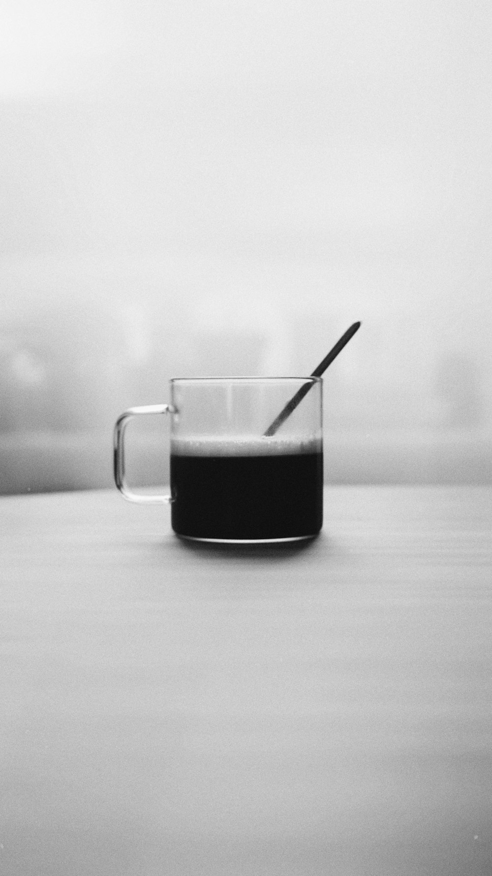 black liquid in clear glass mug