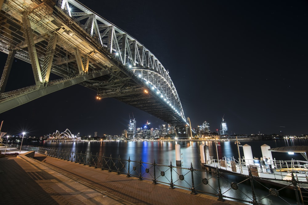 white and blue bridge during night time