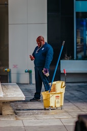 man in blue suit holding yellow plastic basket