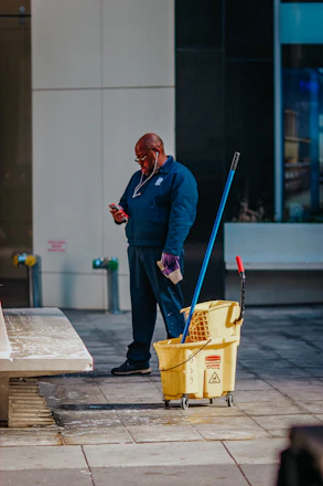 man in blue suit holding yellow plastic basket