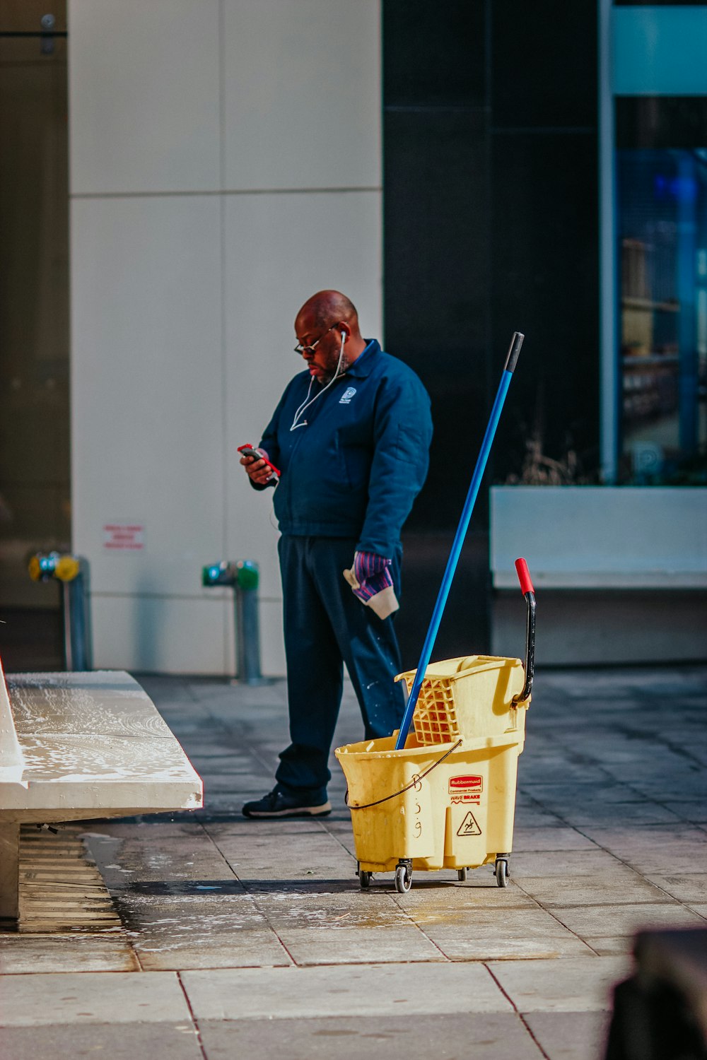 man in blue suit holding yellow plastic basket