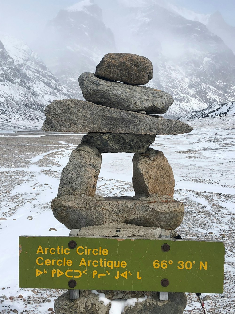 brown rock formation on snow covered ground