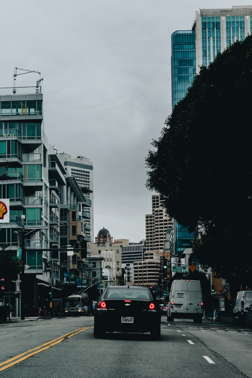 cars on road between buildings during daytime