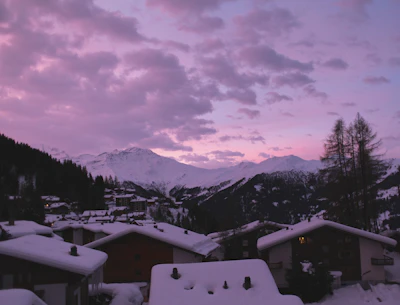 Verbier’s rooftops under snow and a purple evening sky