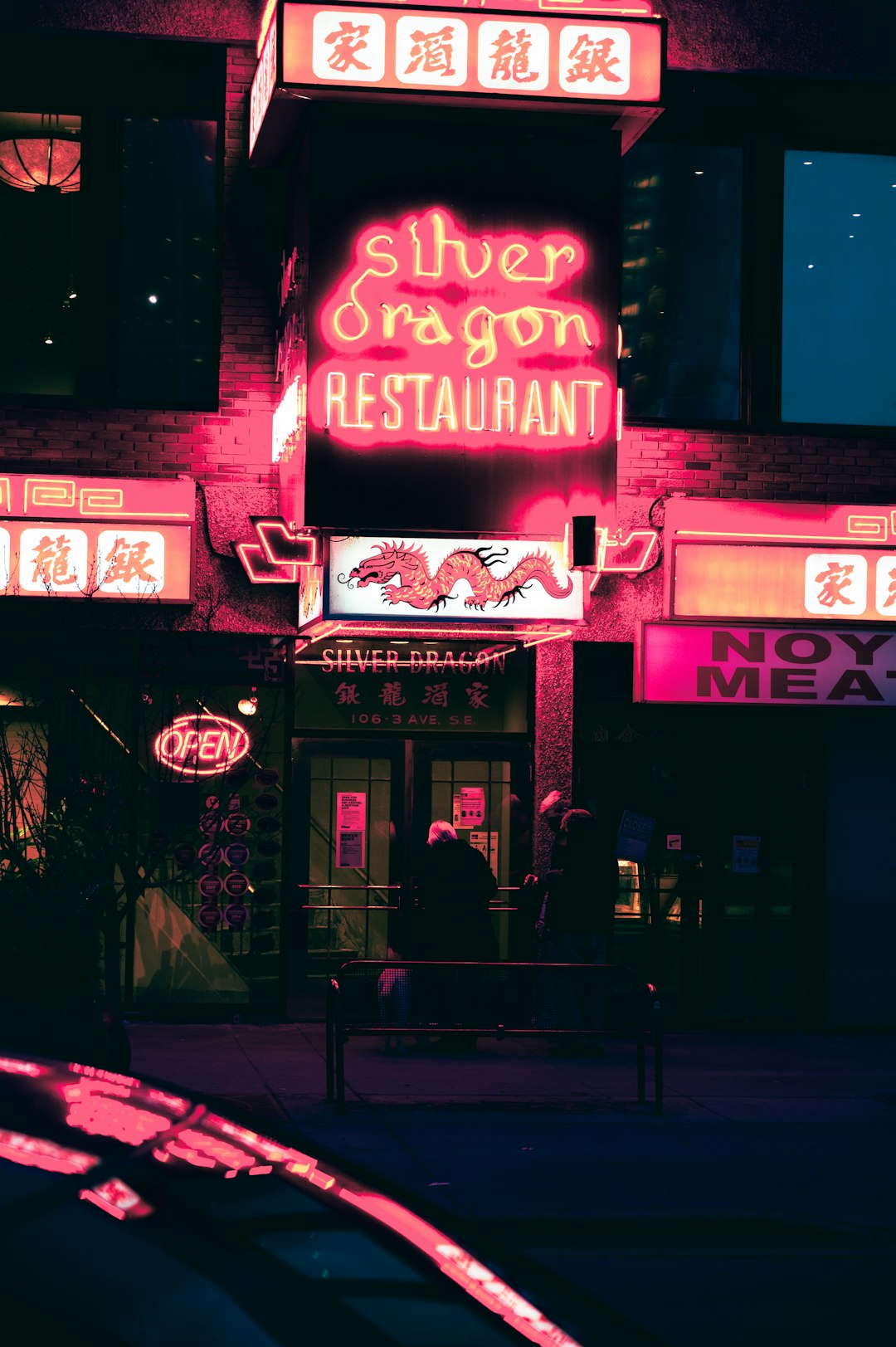 purple and red UNKs bar neon signage