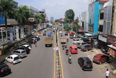 A busy commercial street in Panipat lined with various shops and offices.