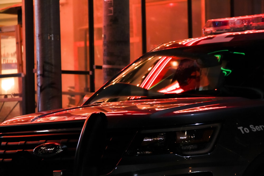 black car in front of brown building