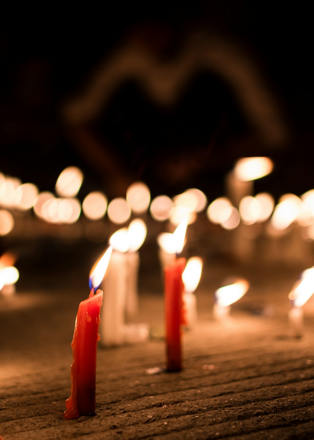 red candles on brown wooden table