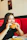 Happy woman sitting at a modern steakhouse table with a delicious burger and fries