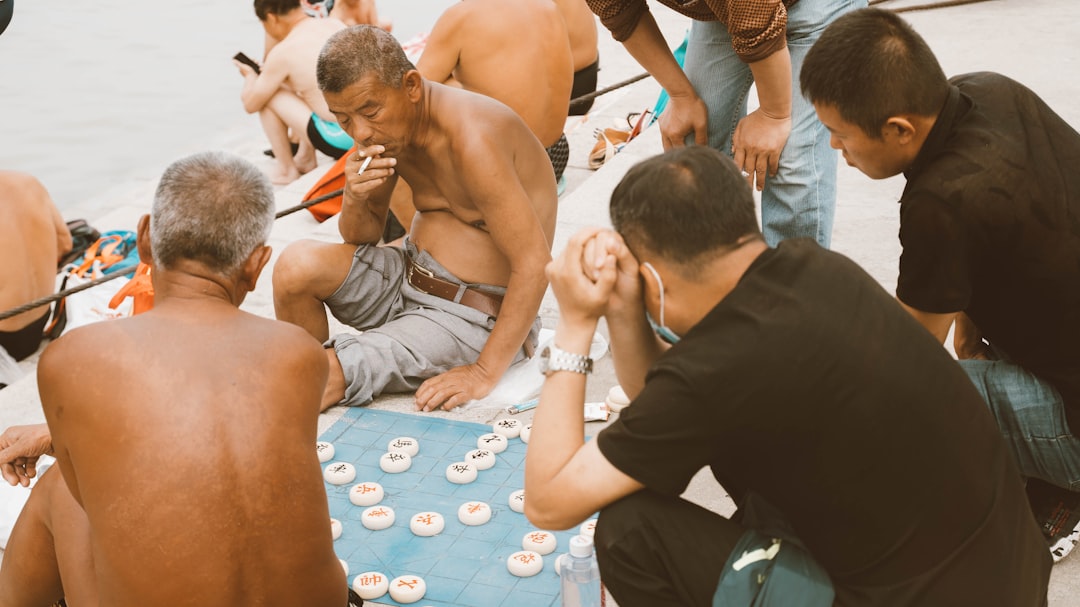 man in black pants sitting on floor