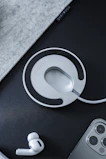A wireless charging pad with an android device resting on it, bathed in soft ambient light.