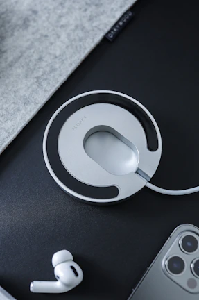 A futuristic wireless charging pad with a minimalist design on a clean desk.