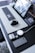 A modern workspace featuring various trendy gadgets like a sleek laptop, wireless headphones, and a stylish desk organizer.