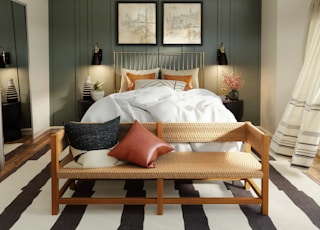 white bed linen on brown wooden bed frame