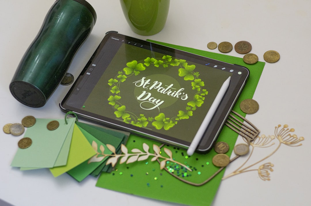 black tablet computer on green table,