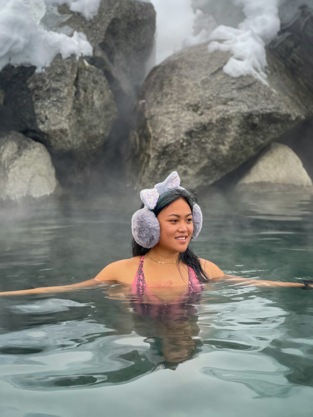 woman in pink bikini top on water during daytime