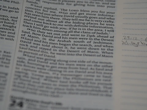 Close-up of a student writing detailed notes from a textbook.