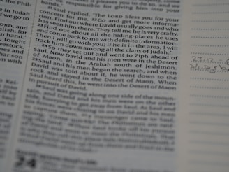 A close-up view of a page from a book, featuring text in paragraph form. The text is focused and readable, and the surrounding area includes lined space for notes with handwritten annotations in the margins.