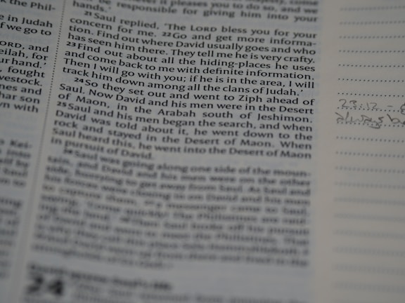 Close-up of a clean, crisp page showing edited text with thoughtful annotations in navy and gold highlights.