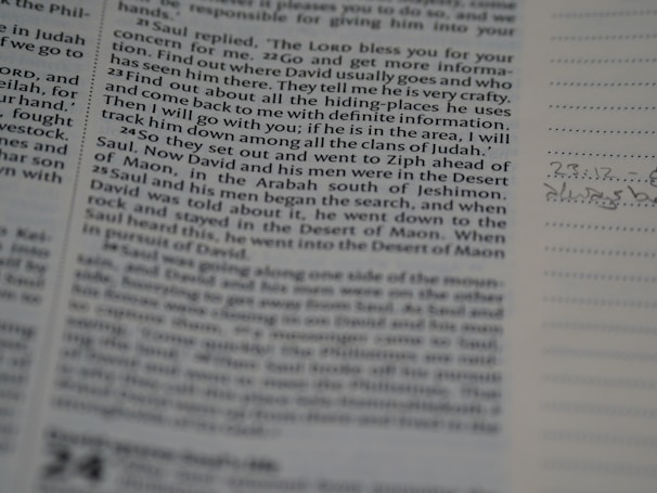 A close-up view of a page from a book, featuring text in paragraph form. The text is focused and readable, and the surrounding area includes lined space for notes with handwritten annotations in the margins.