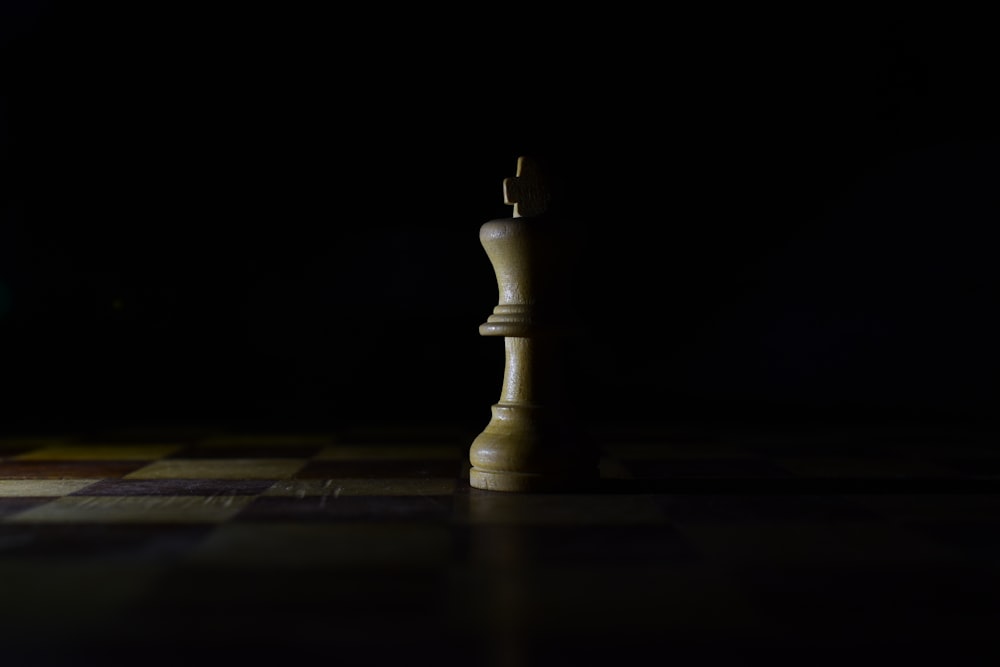 white chess piece on chess piece