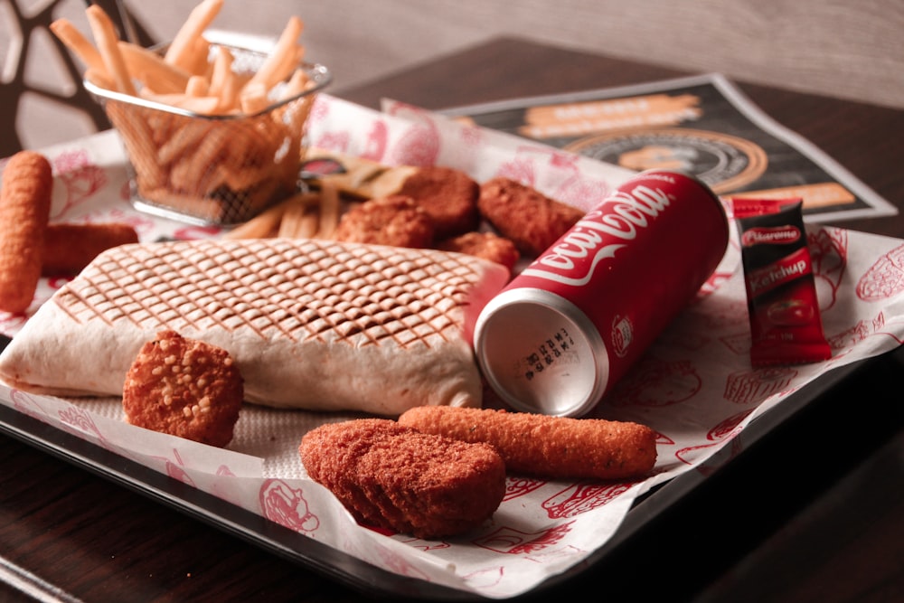 red and white coca cola can beside brown bread on white ceramic plate