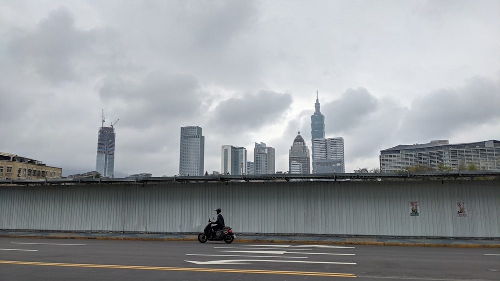 man in black jacket riding motorcycle on road during daytime