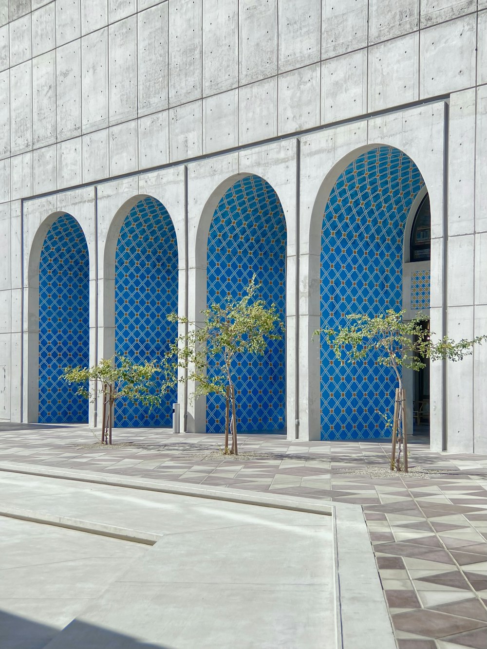 green palm tree near blue concrete building during daytime