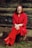 woman in red blazer and black skirt sitting on brown concrete stairs