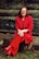 woman in red blazer and black skirt sitting on brown concrete stairs
