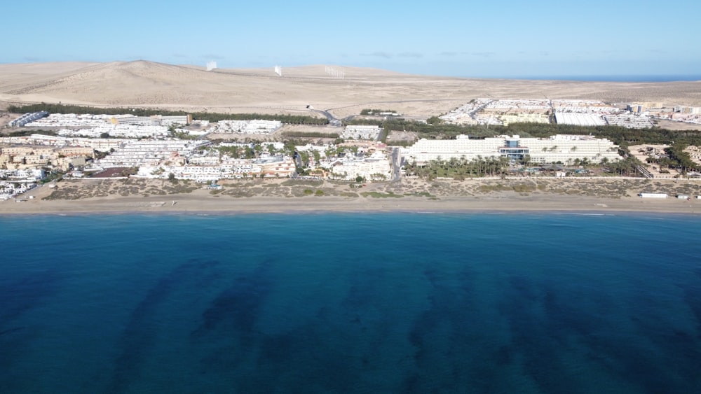 aerial view of city buildings near body of water during daytime