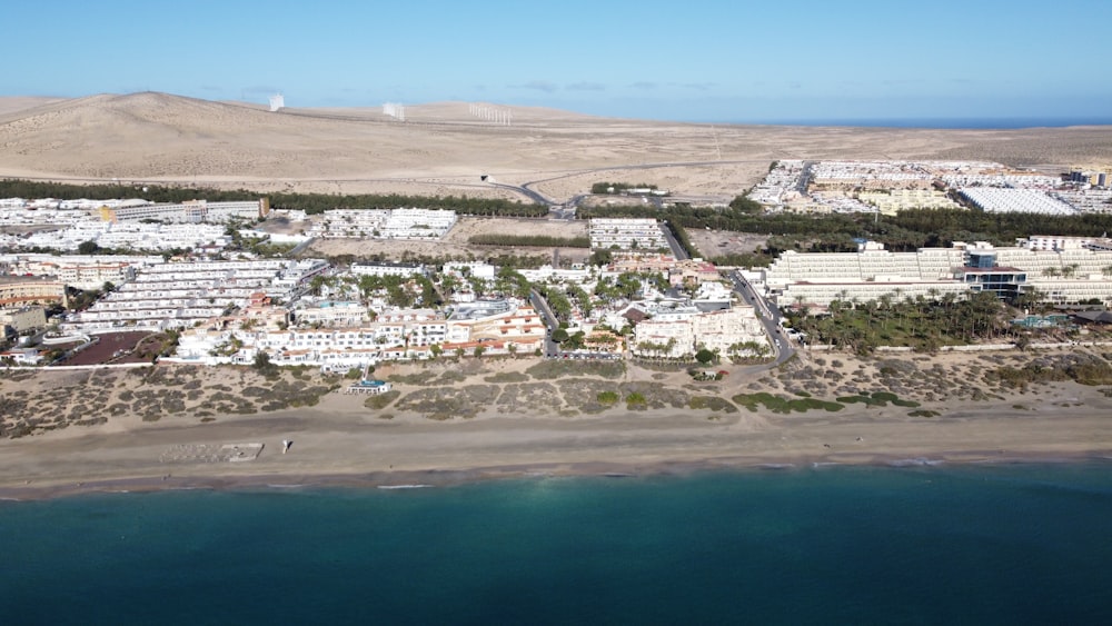 aerial view of city buildings near body of water during daytime