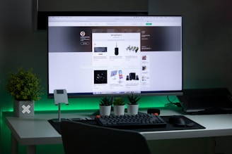 black flat screen computer monitor turned on beside black computer keyboard