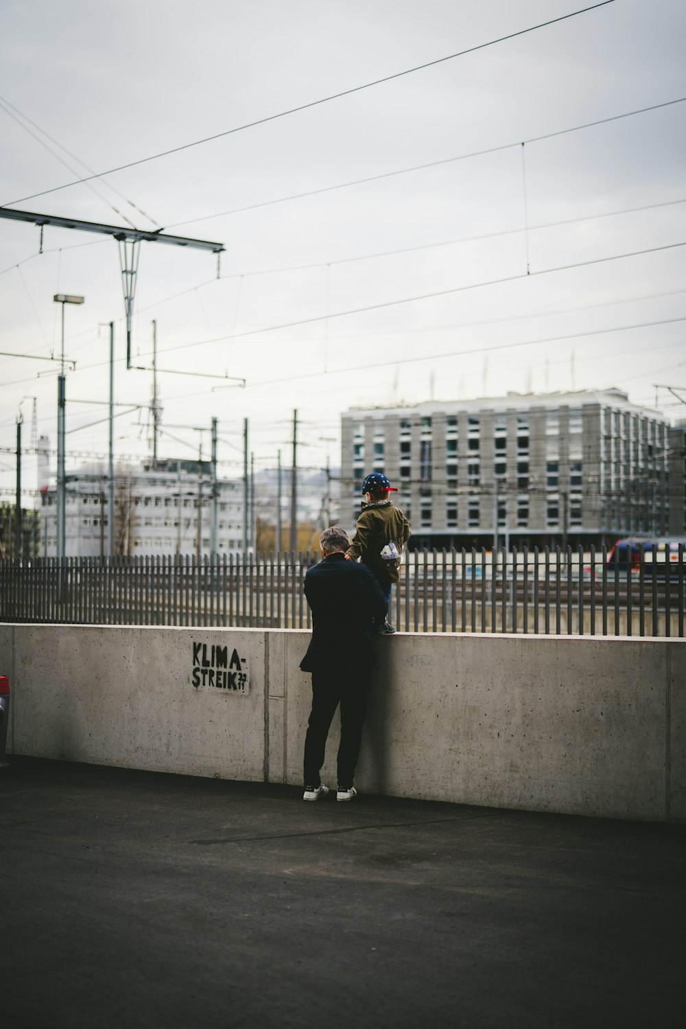 man in black jacket standing beside woman in black coat