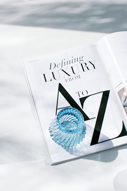 Luxury magazine and glass detail representing premium brand positioning, clarity and considered.
