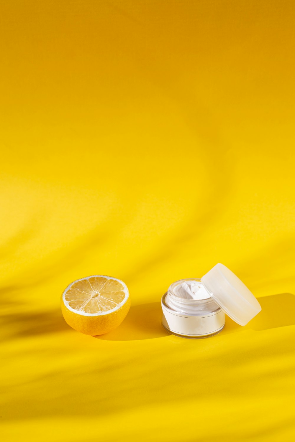 sliced lemon beside white plastic cup