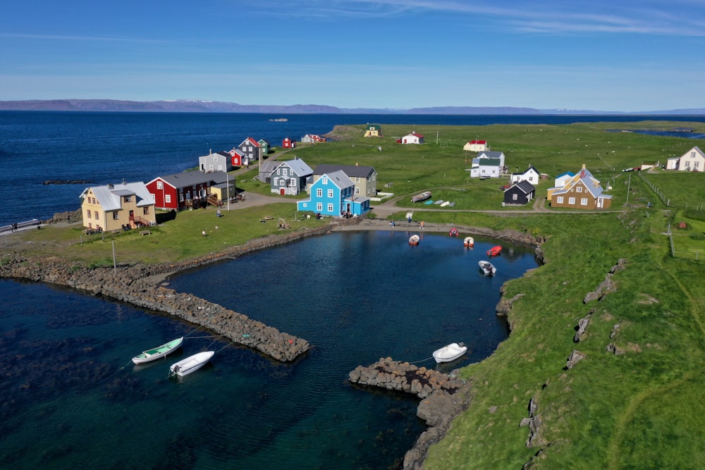 aerial view of houses near body of water during daytime