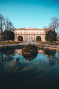 white concrete building near body of water during daytime