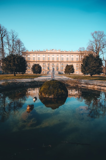 white concrete building near body of water during daytime