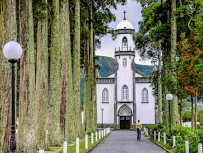 white and blue church near trees during daytime