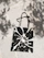 A close-up photo of a hand-sewn tote bag adorned with delicate, whimsical leaf patterns and subtle brush strokes.