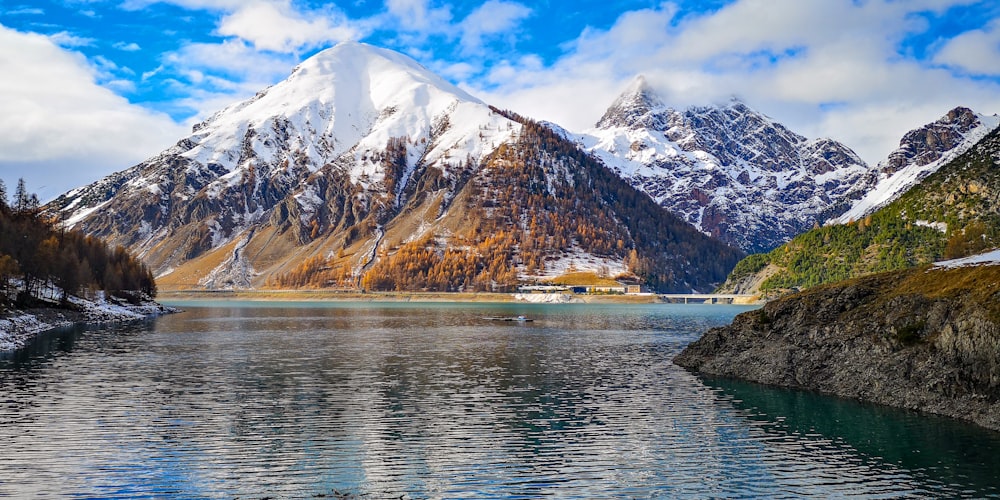 body of water near mountain during daytime