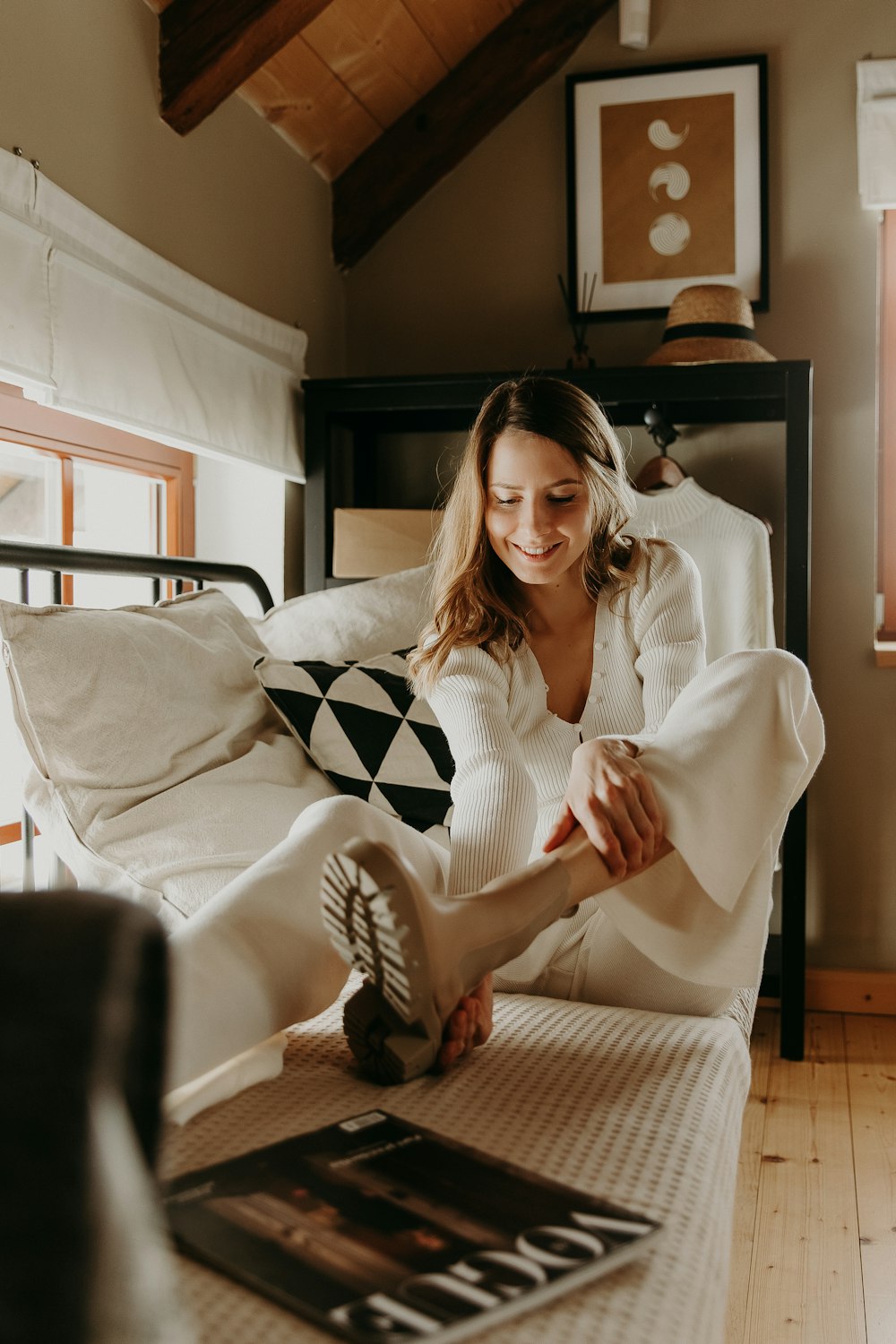 woman in white long sleeve shirt sitting on bed