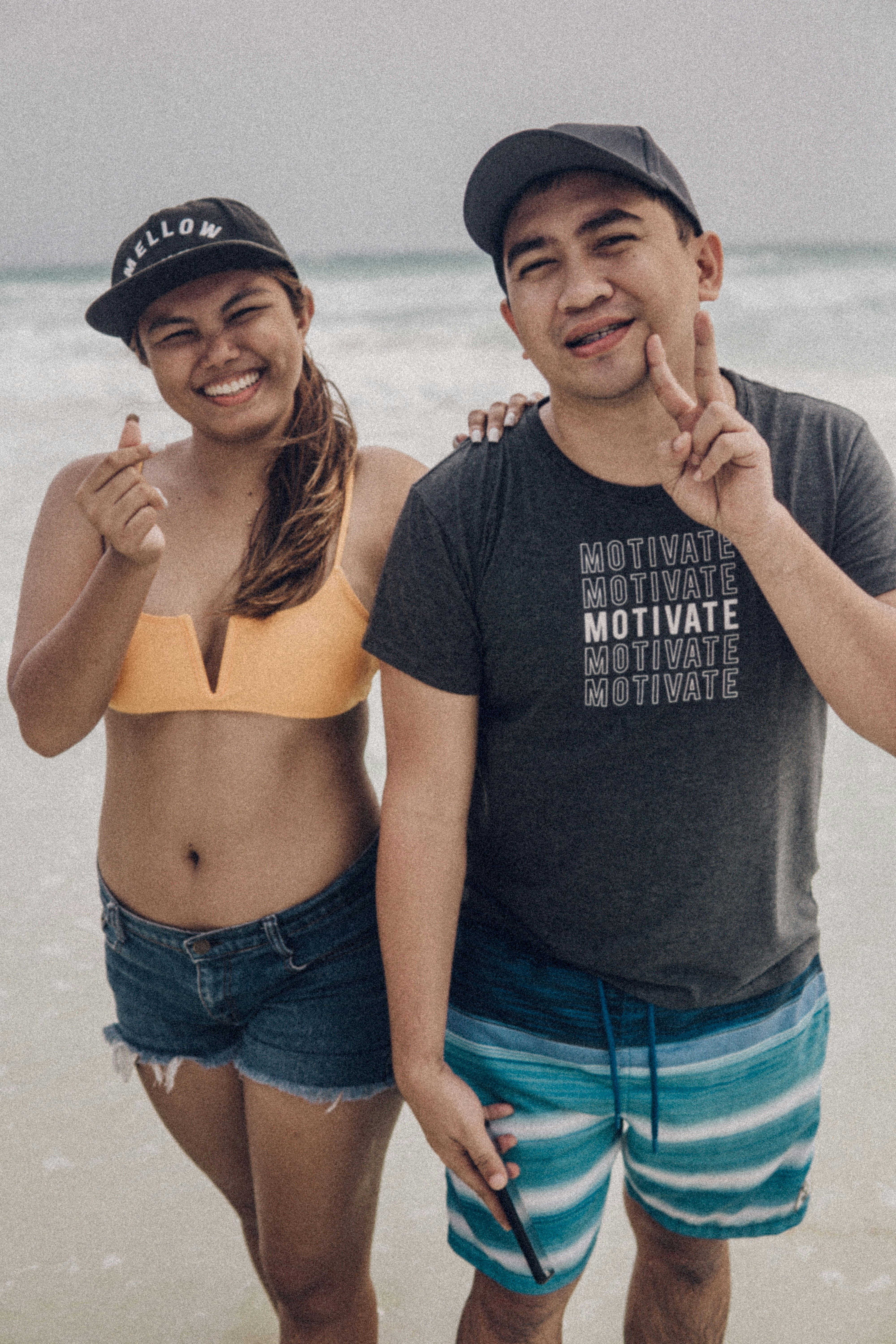 woman in black crop top and blue denim shorts standing beside man in black crew neck