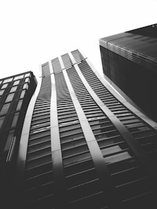 A sleek black and white photo of a modern Dubai skyline with a focus on residential towers.