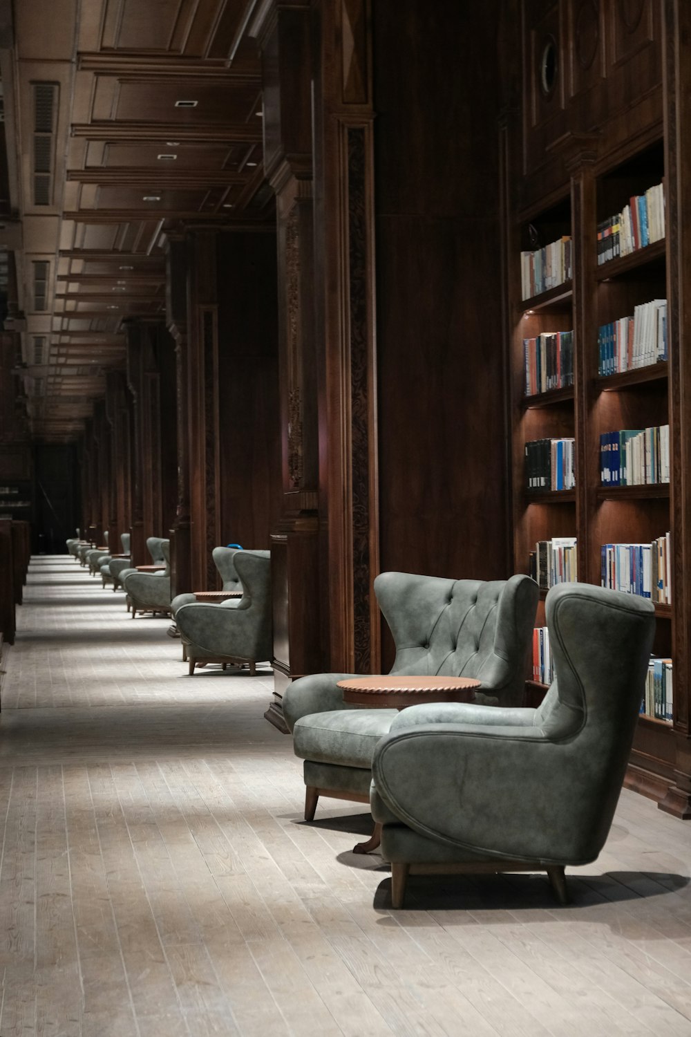 gray padded armchairs on brown wooden floor