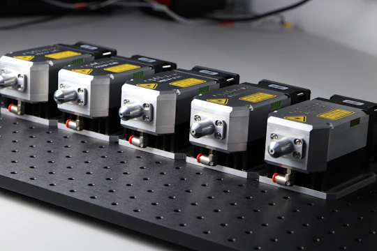 Array of servo drives neatly arranged on a workshop shelf.
