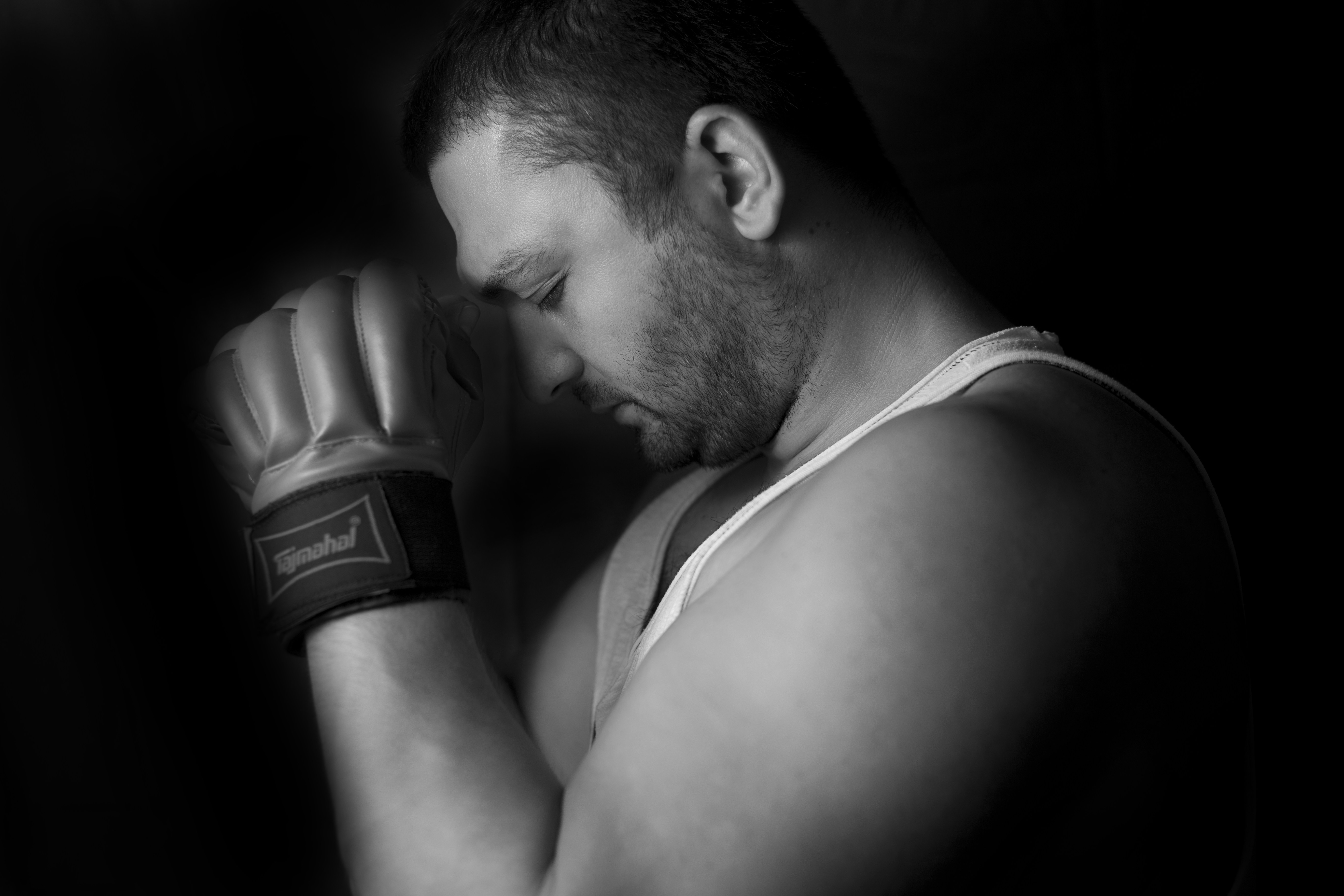man in tank top holding black dslr camera
