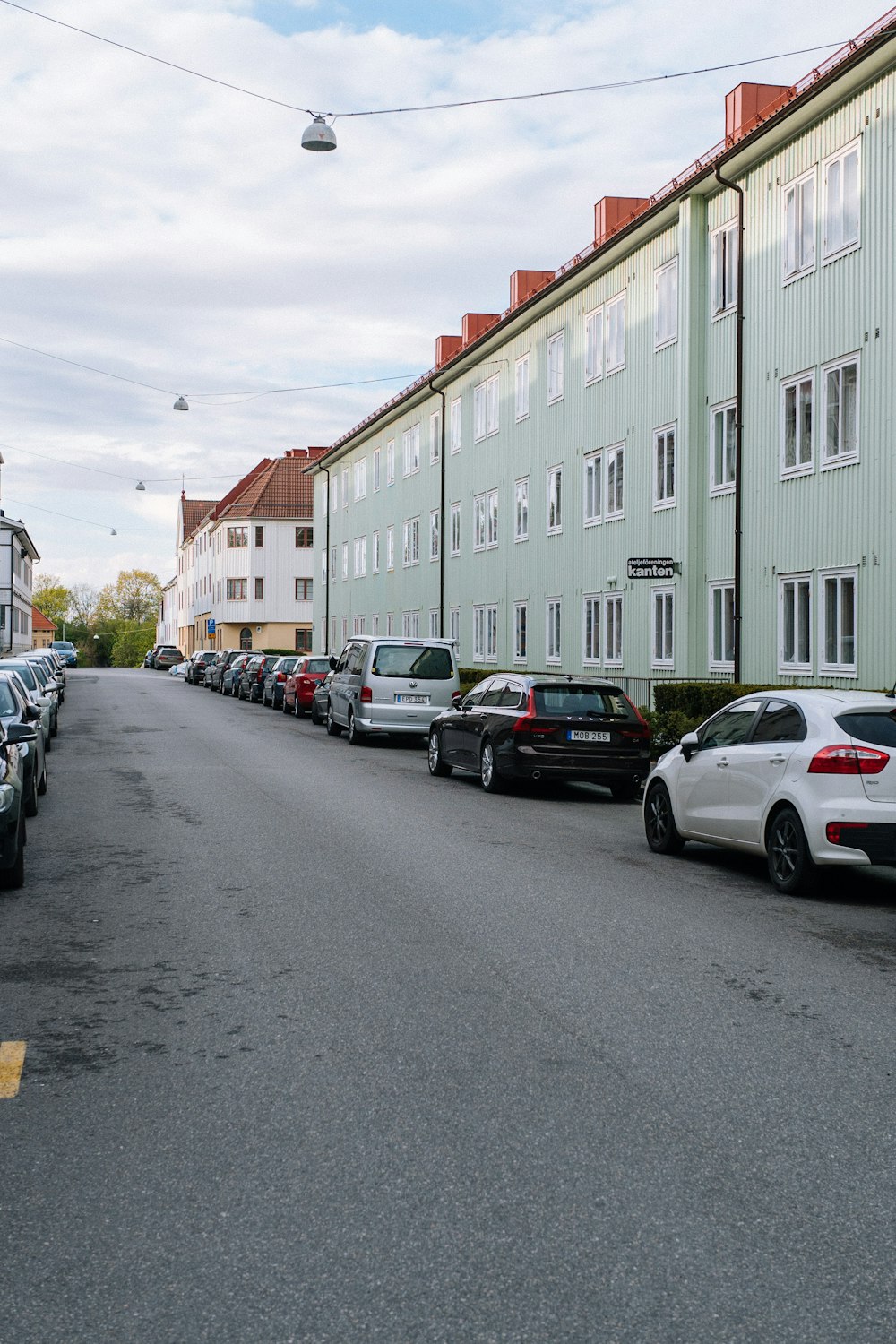 cars parked in front of building during daytime