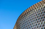 A large laminated glass facade on a commercial building under bright daylight.